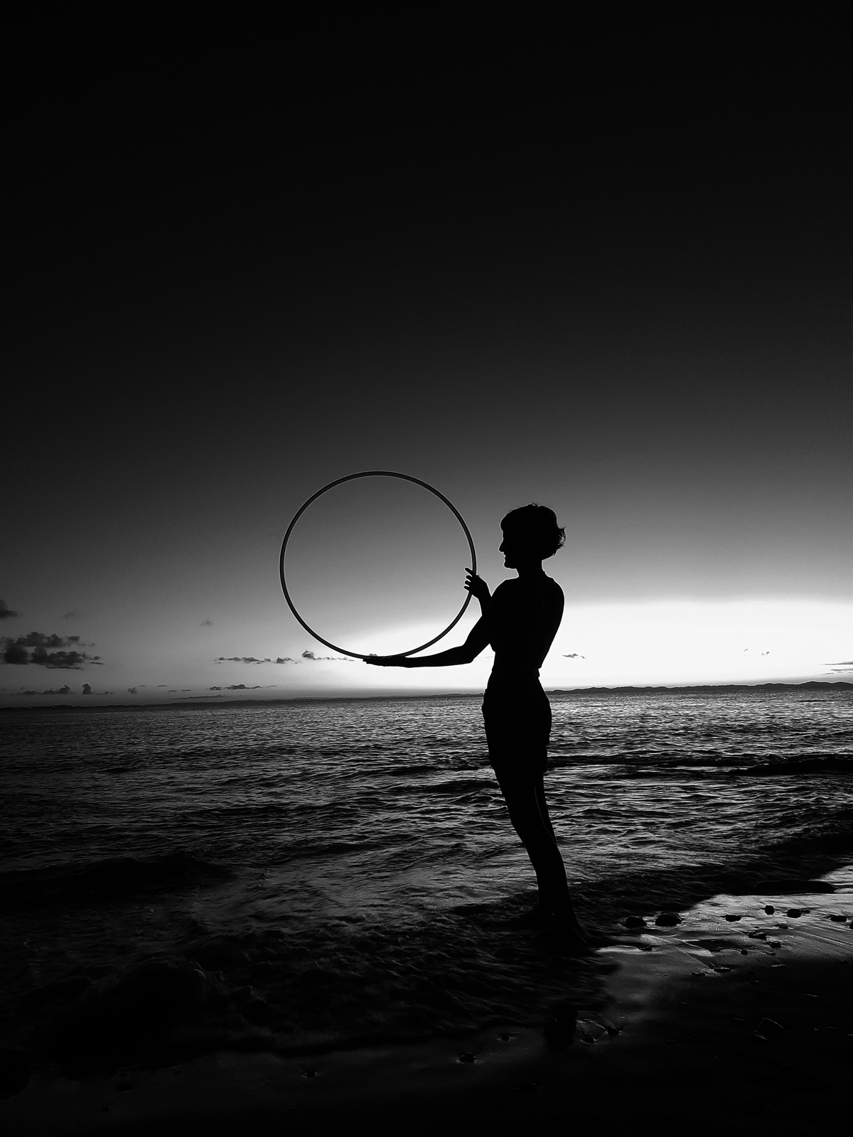 a girl holding a hoop in twilight a girl holding a hoop in twilight